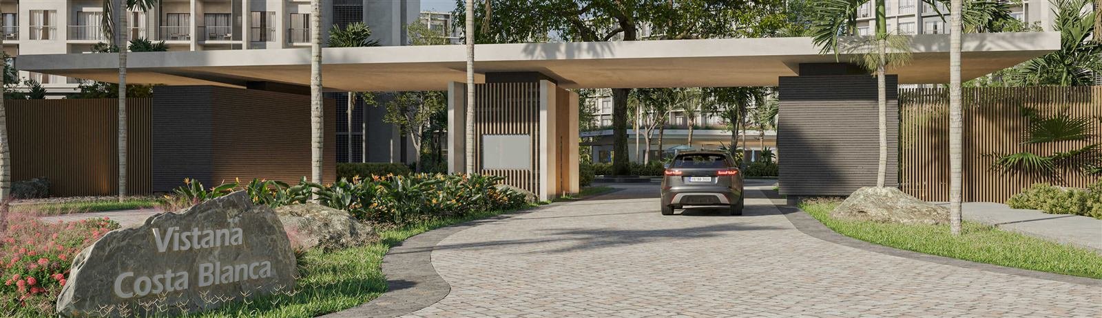 Entrada con palmeras y acceso controlado de un residencial en Boca Chica